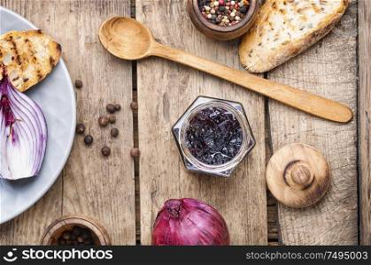 Homemade red onion jam.Onion confiture on old wooden table. Onion jam or onion confiture