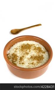 homemade rice with milk and cinnamon in a ceramic bowl isolated on white