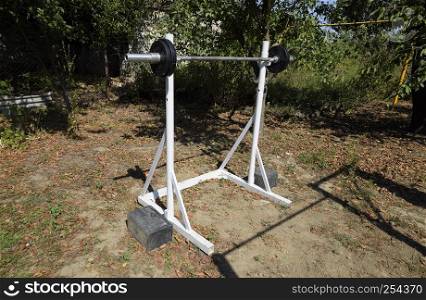 Homemade rod racks. Sports equipment in the backyard. Weightlifting bar. Homemade rod racks. Sports equipment in the backyard. Weightlifting bar.