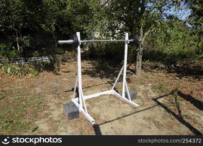 Homemade rod racks. Sports equipment in the backyard. Weightlifting bar. Homemade rod racks. Sports equipment in the backyard. Weightlifting bar.