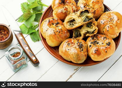 Homemade rustic nettle and spinach buns on white background. Appetizing bun with nettles.