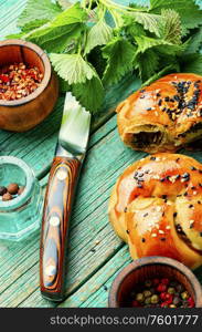 Homemade rustic nettle and spinach buns on wooden table. Homemade buns with nettles.