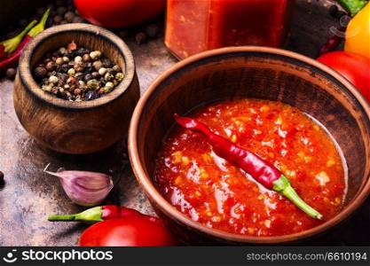 Homemade sauce adjika with pepper, garlic and tomatoes.Barbeque sauce. Spicy seasoning, adjika sauce