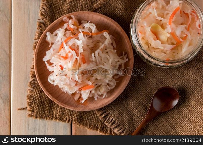 Homemade sauerkraut on a linen background. Rustic style, canned vegetables on a light wooden background. Eco food, the trend of healthy eating.