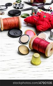 Homemade sewing tools. Threads for sewing and set of buttons from clothing.Copy space