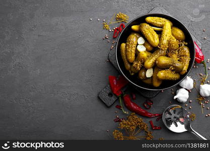 Homemade small preserved cucumbers, fermented, salted or marinated pickles with garlic, chili and dill