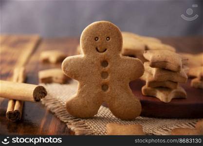 Homemade smiling gingerbread man cookie, traditionally made at Christmas and the holidays. Closeup.