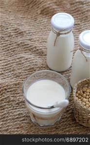 Homemade soy milk for breakfast drink, soya milk and soybean on burlap background, this beverage rich omega, protein, fibre, also delicious, nutrition, healthy drink