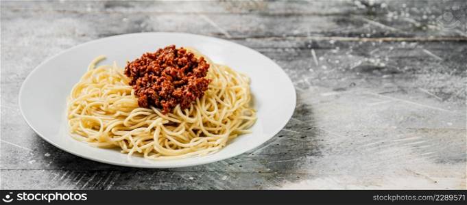 Homemade spaghetti bolognese. On a gray background. High quality photo. Homemade spaghetti bolognese. On a gray background.