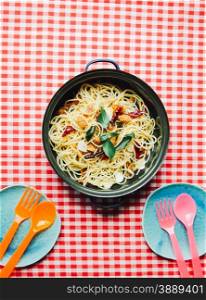 Homemade spaghetti with colorful dish and spoon with fork