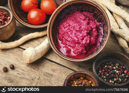 Homemade spicy horseradish seasoning sauce on wooden table. Spicy horseradish sauce