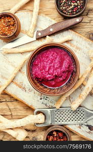 Homemade spicy horseradish seasoning sauce on wooden table. Spicy horseradish sauce