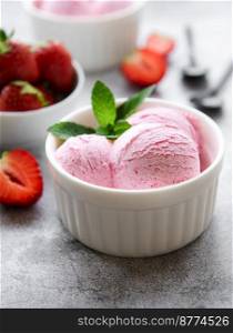 Homemade strawberry  ice cream with fresh strawberries. Sweet berry summer dessert. Concrete background