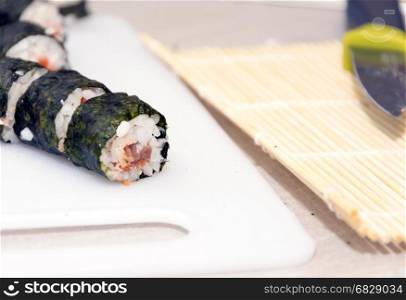 homemade sushi rolls on a white cutboards