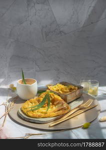 Homemade sweet frying roti (Cannabis Pancake) with Cannabis served with Cannabis tea on ceramic tray. Concept of food with cannabis herb, Treatment of medical marijuana for use in food, Copy space, Selective focus.