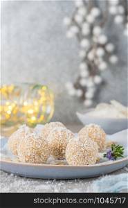 Homemade sweet white chocolate and coconut in a plate. Raffaello candy - snowball truffles on a Christmas table