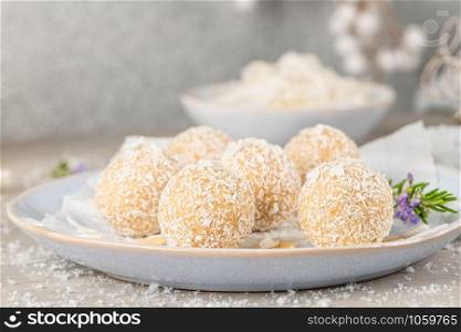Homemade sweet white chocolate and coconut in a plate. Candy - snowball truffles on a Christmas table