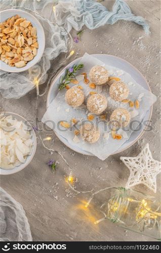 Homemade sweet white chocolate and coconut in a plate. Raffaello candy - snowball truffles on a Christmas table. Top view.