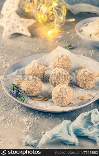Homemade sweet white chocolate and coconut in a plate. Raffaello candy - snowball truffles on a Christmas table