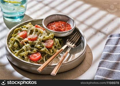 Homemade Tagliatelle pasta with zucchini, tomatoes and cod.