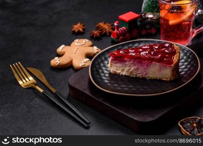Homemade tasty cheesecake with jelly and raspberry berries on a black plate on a dark concrete background. Homemade tasty cheesecake with jelly and raspberry berries on a black plate