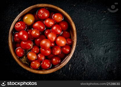 Homemade tomatoes for pickling in a plate. On a black background. High quality photo. Homemade tomatoes for pickling in a plate.