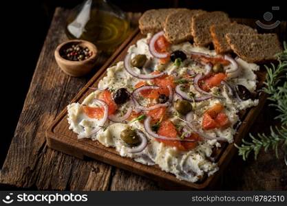 Homemade trendy Butter Board with olives, red fish, red onion and herbs with bread. Homemade trendy Butter Board