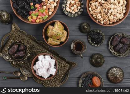 homemade turkish delight baklava dates dried fruits nuts metallic earthen bowl table. High resolution photo. homemade turkish delight baklava dates dried fruits nuts metallic earthen bowl table. High quality photo