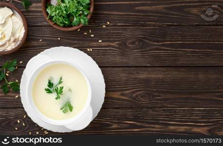 Homemade Turkish yogurt soup (yayla soup), seasonal, summer soup, served hot or cold. Healthy wholesome food, the first starter dish. Top view, copy space
