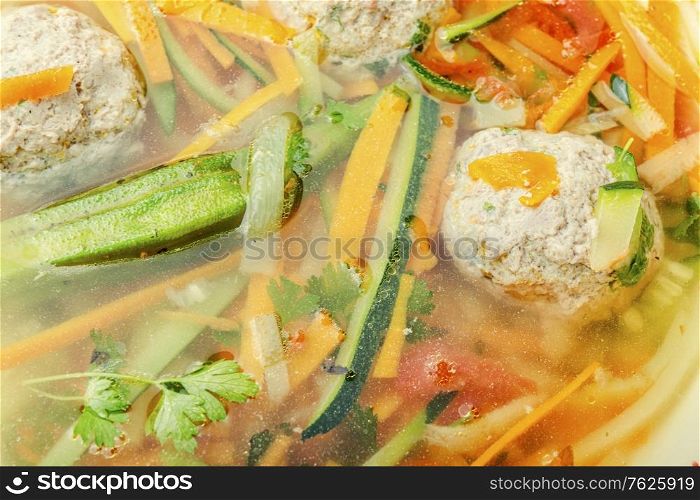 Homemade vegetable soup with meatballs and vegetables.Soup with zucchini.. Soup with meatballs and zucchini