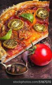 Homemade vegetarian pizza. Healthy vegan pizza with tomato on bronze retro background.