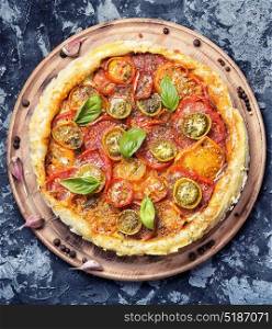 Homemade vegetarian pizza. Healthy vegetarian pizza with tomato on old wooden table
