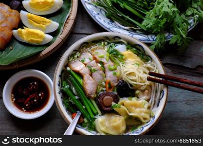 Homemade Vietnam food, egg noodle soup with wontons, colorful food ingredient for this eating as egg, pork, broth, shallot, bean sprout, agaric, vegetable