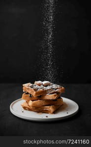 Homemade waffles with fruit and granola.