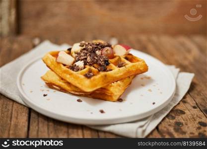 Homemade waffles with fruit and granola. 