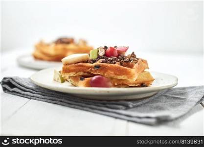 Homemade waffles with fruit and granola. 