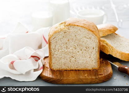 Homemade white wholegrain bread sliced on wooden board