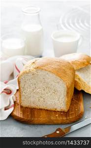 Homemade white wholegrain bread sliced on wooden board