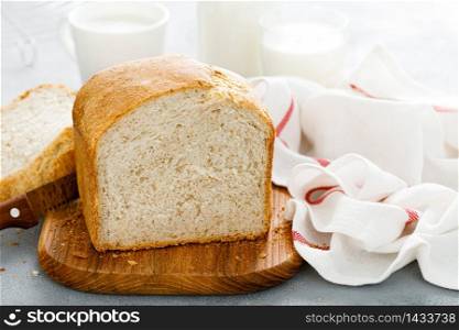 Homemade white wholegrain bread sliced on wooden board