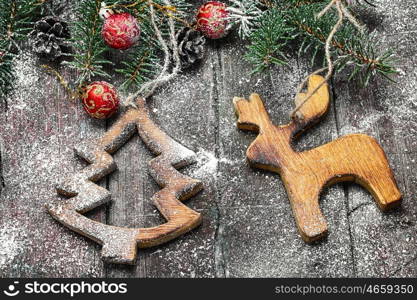 Homemade wooden Christmas ornaments. Wooden decorative fir-tree decoration on Christmas background