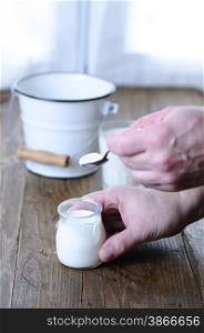 Homemade yogurt on wooden table in the kitchen&#xA;