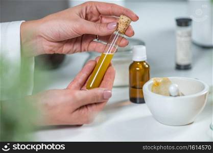 Homeopathy lab. Homeopath preparing alternative herbal medicines.