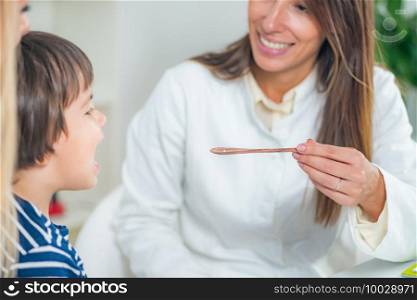 Homeopathy. Mother and little boy visiting a homeopath