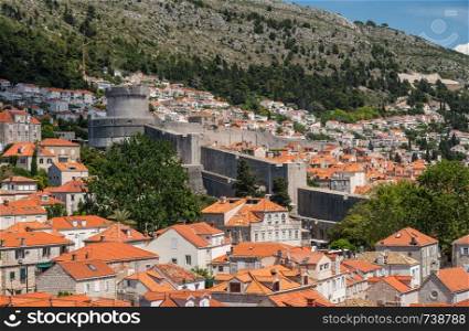 Homes and houses crowded on the hillside outside city walls in Dubrovnik in Croatia. Residential homes and apartments outside city walls of Dubrovnik old town
