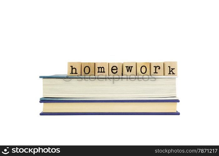 homework word on wood stamps stack on books, school and assignment concepts