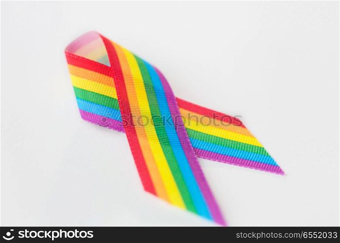 homosexual and lgbt concept - close up of gay pride awareness ribbon on white background. close up of gay pride awareness ribbon on white. close up of gay pride awareness ribbon on white