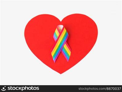 homosexual and lgbt concept - gay pride awareness ribbon on red heart shape over white background. gay pride awareness ribbon on red heart. gay pride awareness ribbon on red heart