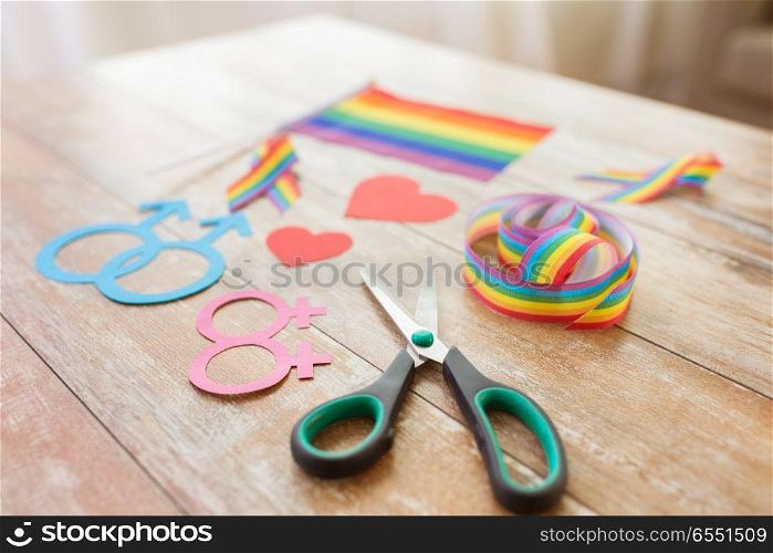 homosexual and lgbt concept - scissors and gay party props on wooden table. scissors and gay party props on wooden table. scissors and gay party props on wooden table