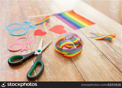 homosexual and lgbt concept - scissors and gay party props on wooden table. scissors and gay party props on wooden table. scissors and gay party props on wooden table
