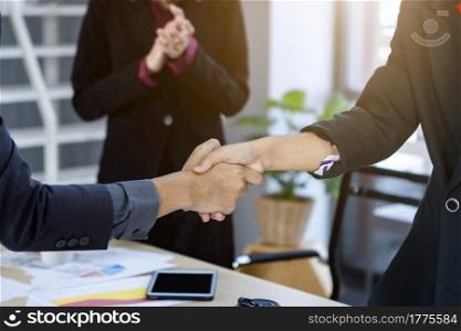 Homosexual businessman LGBT partners and businessman shaking hands at In the office room background after the contract is signed or handshake greeting deal,business expressed confidence embolden